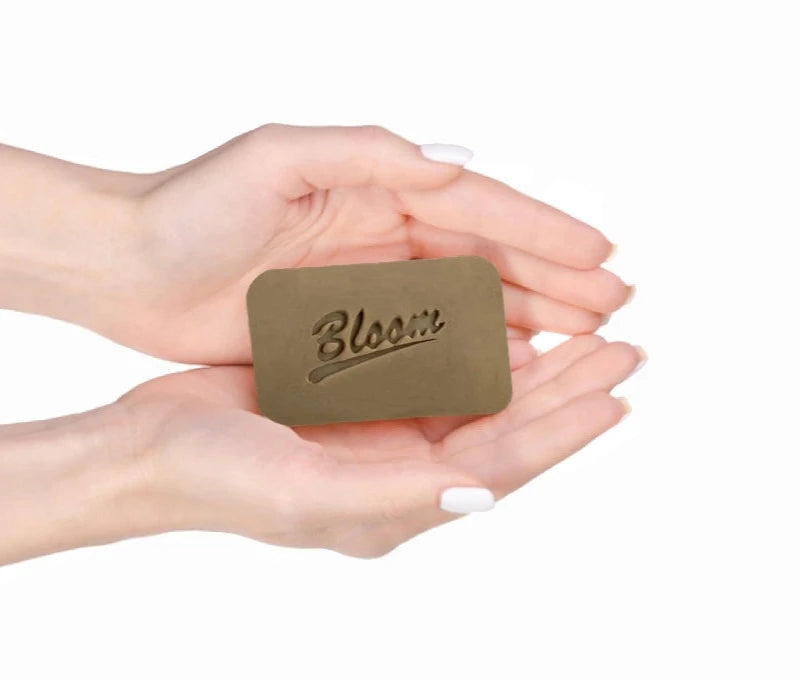 Bloom Dead Sea Soap held in hands, showcasing natural ingredients for skin rejuvenation and hydration